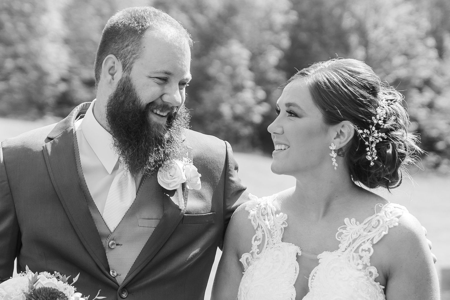 Candid wedding photos of a couple sharing joyful moments outdoors.
