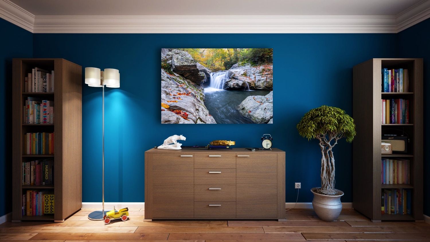A room painted blue with a fine art print from Jonathan Sprigler hanging above a cabinet