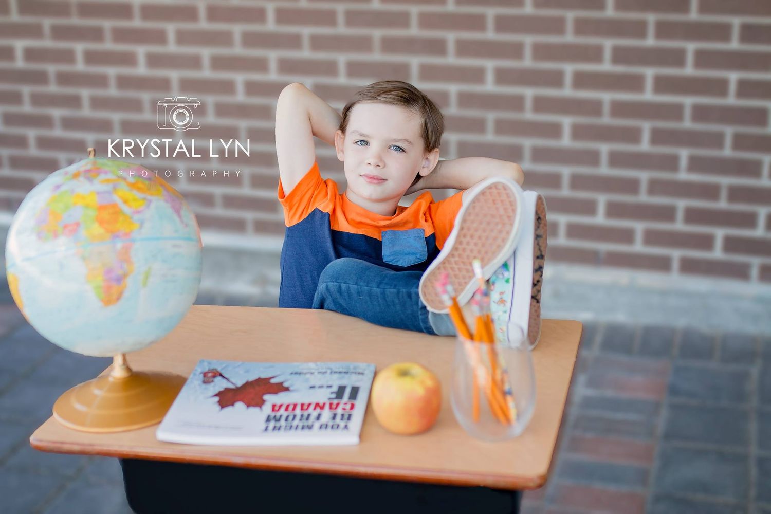 Outdoor school photo with props including a globe