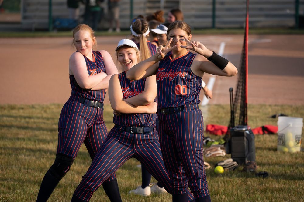 Softball players posing to the camera. Image taken by Todd Sloan Photography.