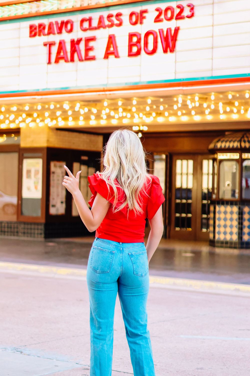 Theater marquee displays 'Class of 2023' with bright lights and red lettering.