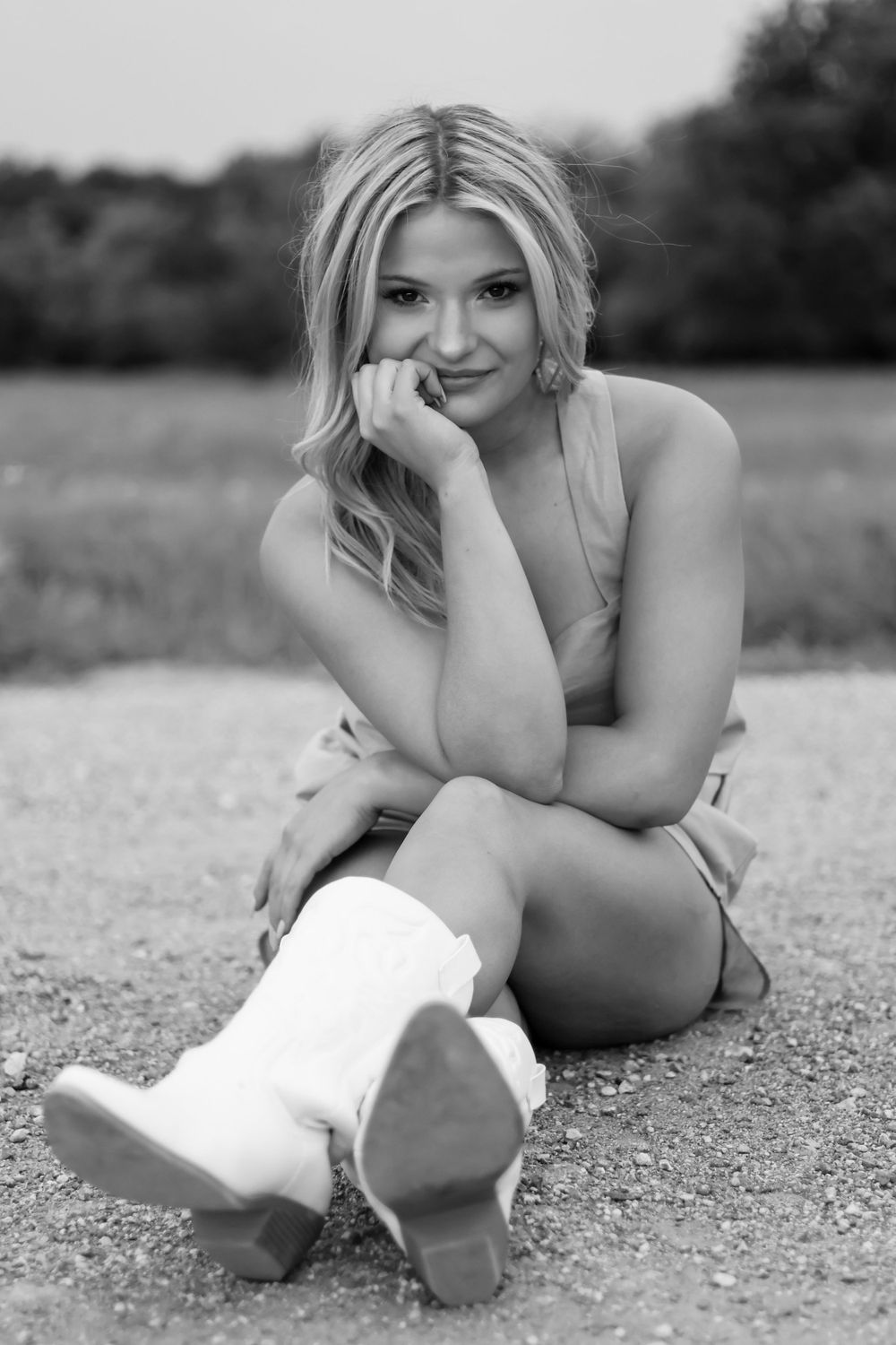 Black and white photo series of person laying on ground in artistic pose.