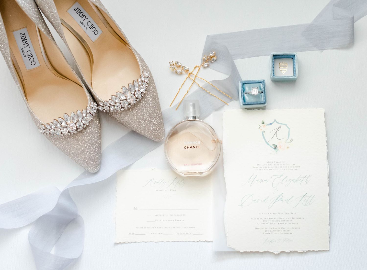 The image shows various wedding accessories including shoes, jewelry, and a wedding invitation.