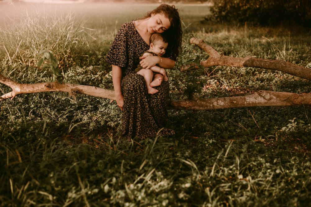 An intimate outdoor portrait in tall grass during golden hour.