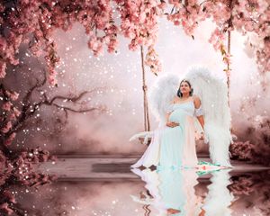Ethereal photoshoot in a garden with pink cherry blossoms and soft lighting creating a dreamy atmosphere.