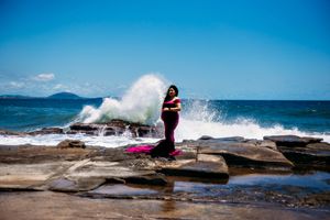 Dynamic seaside photo sequence with waves splashing over coastal rocks.