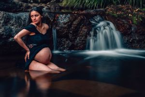 Long exposure waterfall photography with dark moody tones and smooth water motion.