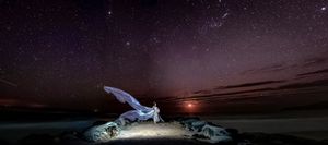 Night sky photography showing stars and celestial objects in a dark landscape setting.