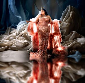 Glamorous studio portrait series with coral-colored sparkles and dramatic lighting.