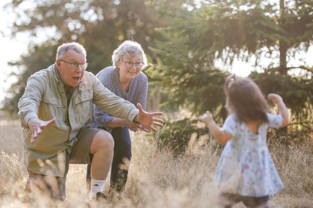 Everett extended family photographer: A grandma and grandpa play with their granddaughter at an extended family photo shoot in Seattle WA