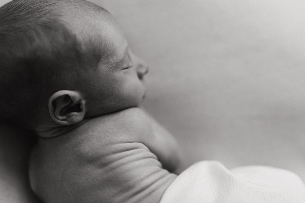 Edmonton Newborn Photographers.  Edmonton natural candid minimalist newborn photographer.  No props photographers.  baby rolls