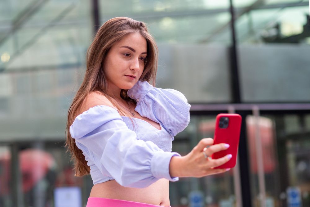 Ukrainian model Stasia wearing a half top taking a selfie in London