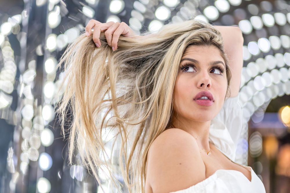 Stunning photo of gorgeous Brazilian model, Beatriz Sonnewend holding her hair up in London light tunnel