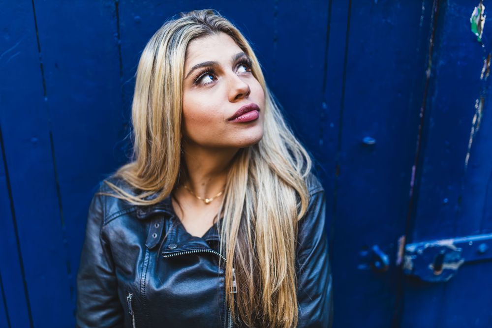 Beautiful Brazilian model, Beatriz Sonnewend looking up to the right against a dark blue door