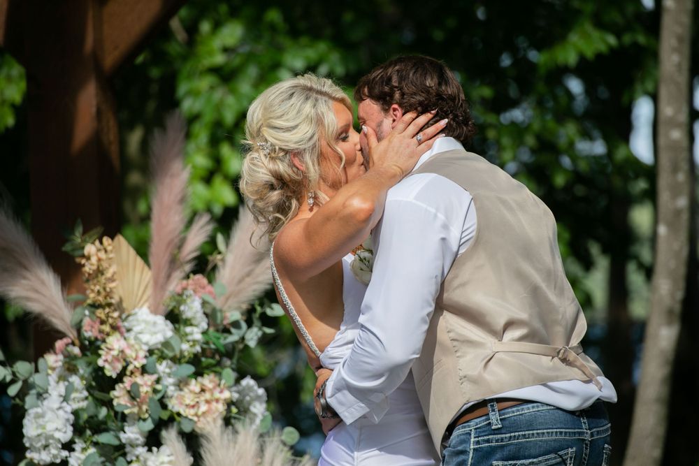 bride and groom share first kiss as husband and wife after their ceremony at Lanier islands