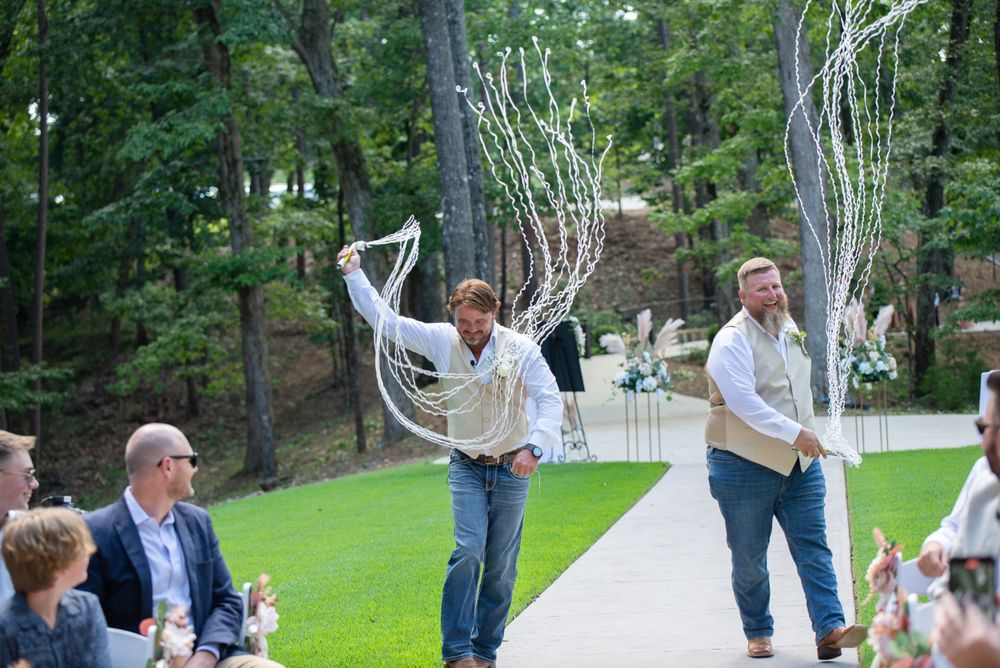 groom and best man walk down aisle before wedding ceremony at Lanier islands