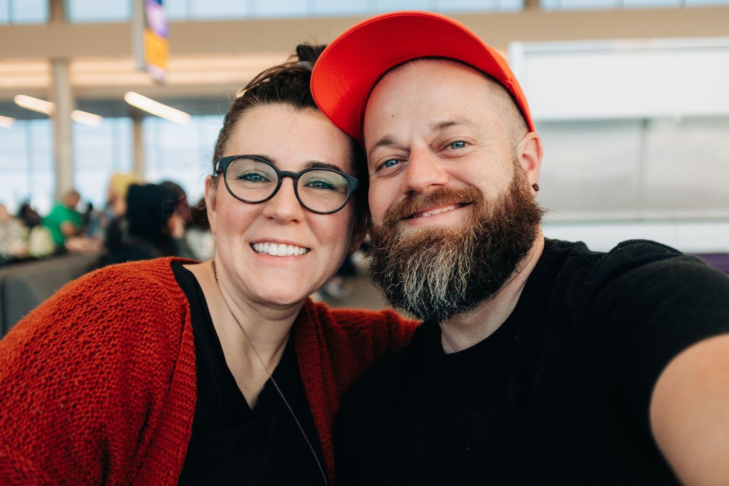 A cheerful portrait of two friends in a bright indoor setting.