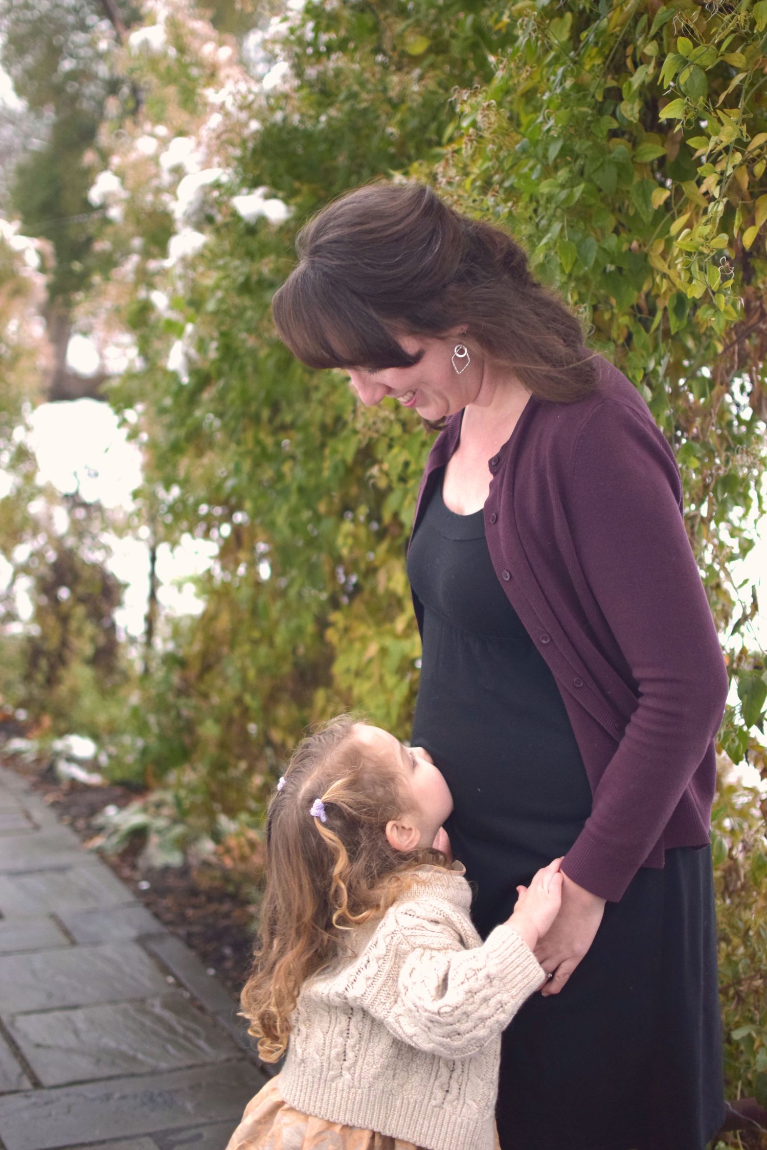 sister baby kiss maternity family photo