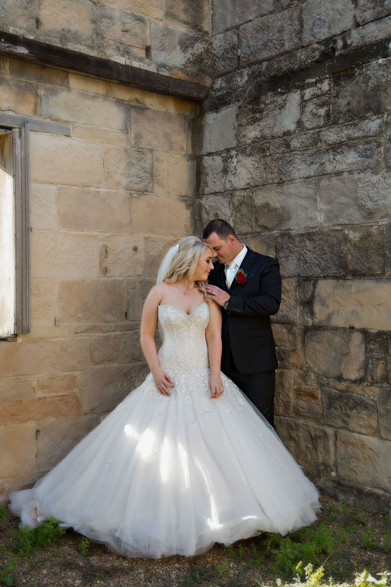 The groom touches his brides shoulder and they both take the moment in.