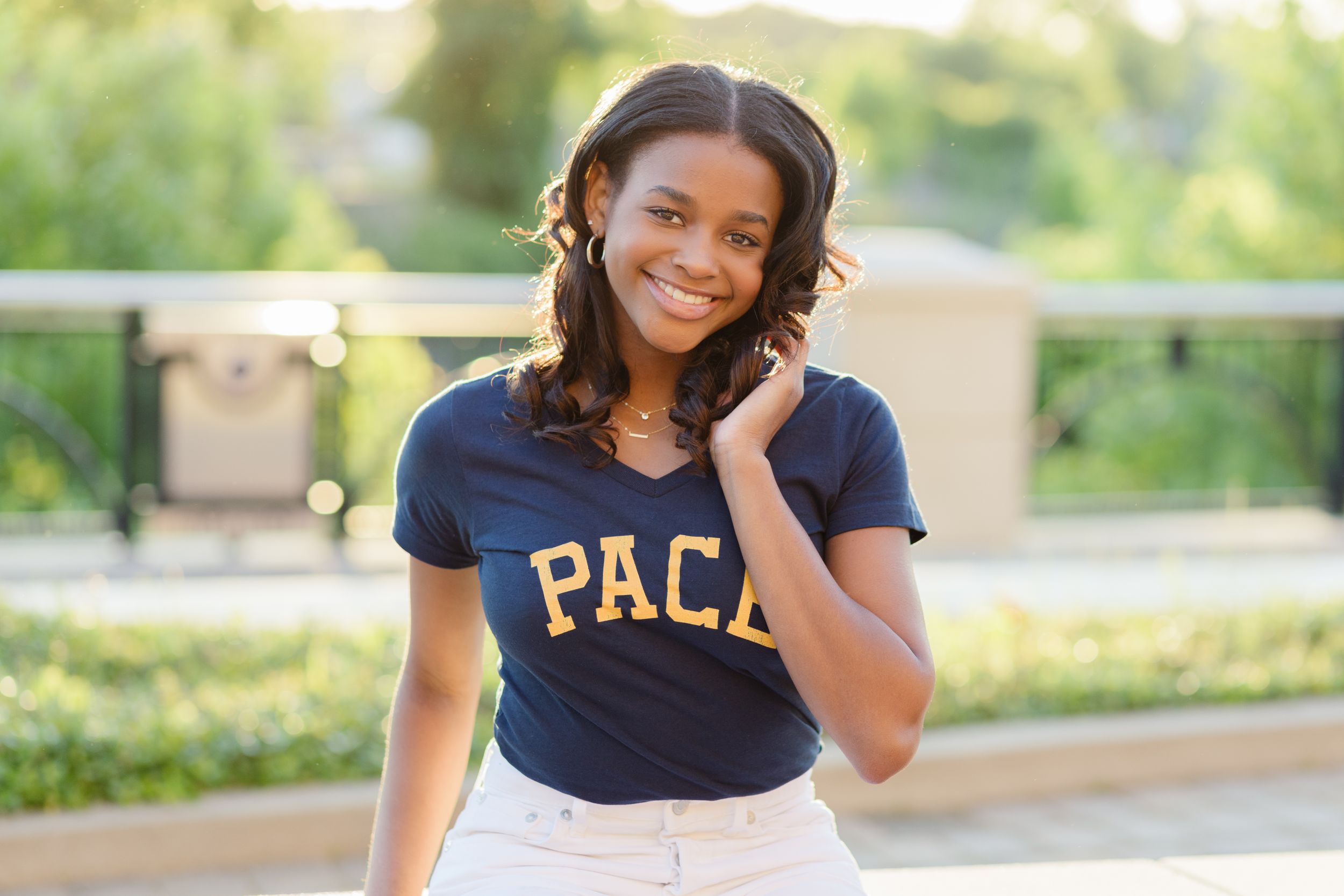 Casual outdoor portrait wearing navy PACA t-shirt and light pants.