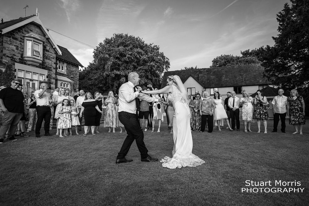 Bride and grooms first dance is outdoors at west tower wedding venue. Ormskirk wedding photographer. Lancashire wedding.
