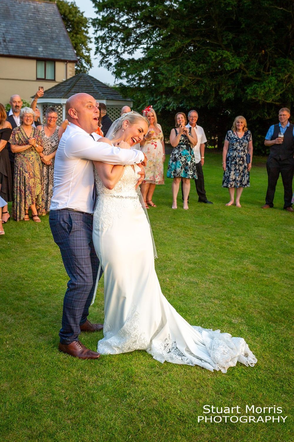 Groom hugs the bride from behind during their first dance. West tower wedding photography. Ormskirk wedding photographer