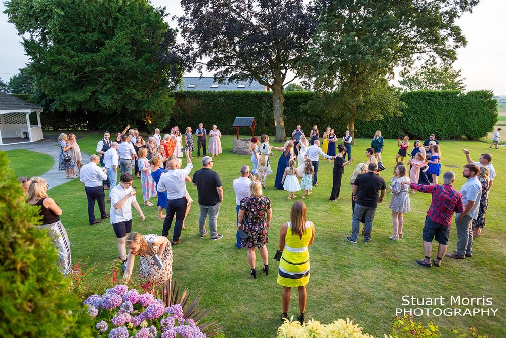Wedding guests having fun in the grounds at west tower country house wedding venue. Lancashire wedding photographer.