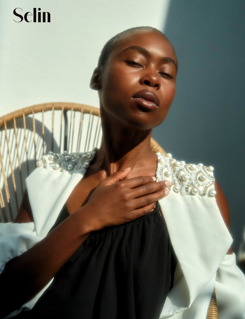 Natural lighting fashion editorial portrait with dramatic shadows and styling.