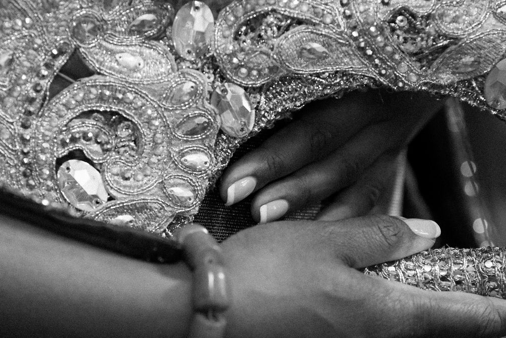 Close-up details of intricate silver and crystal beadwork on traditional wedding attire.
