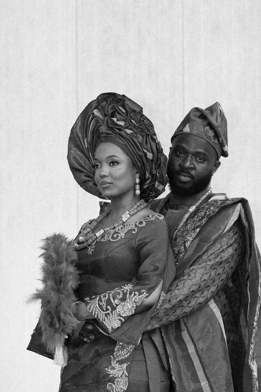 Black and white portrait series of a couple in ornate traditional African wedding attire.