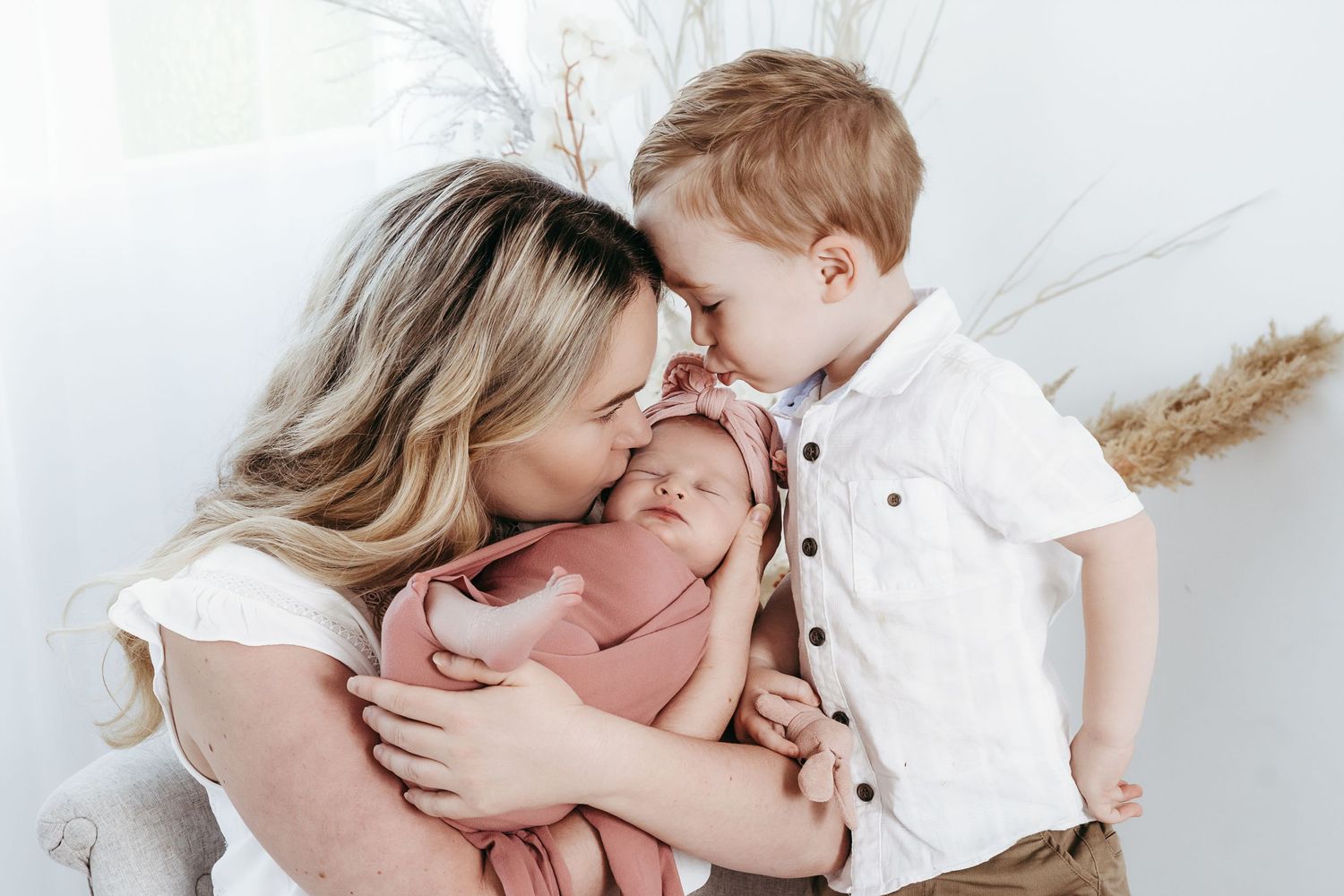 A touching intimate moment shared between family members on a white background.