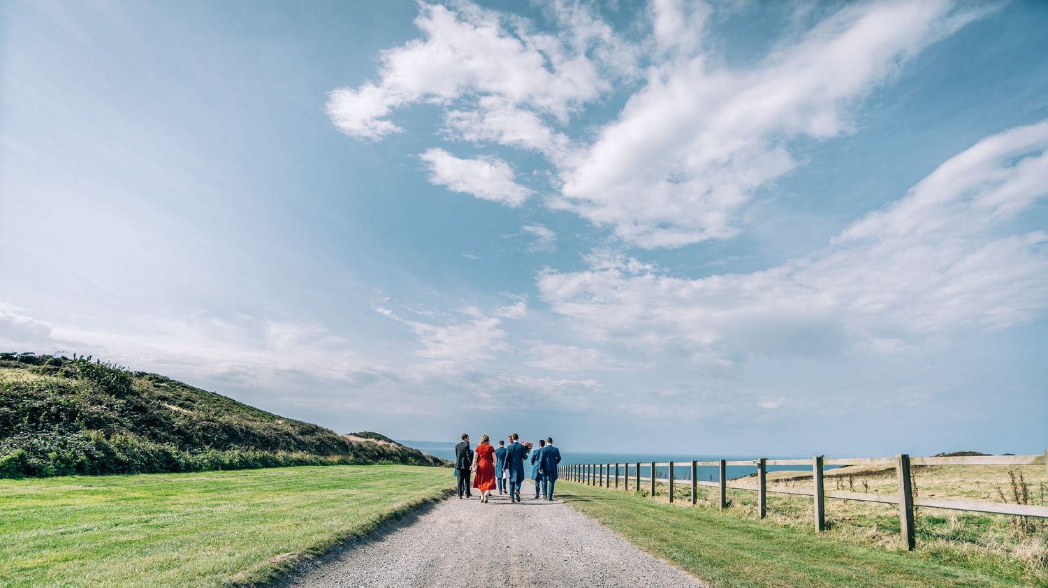 Panoramic of Groom and friends walking down to the ceremony.
