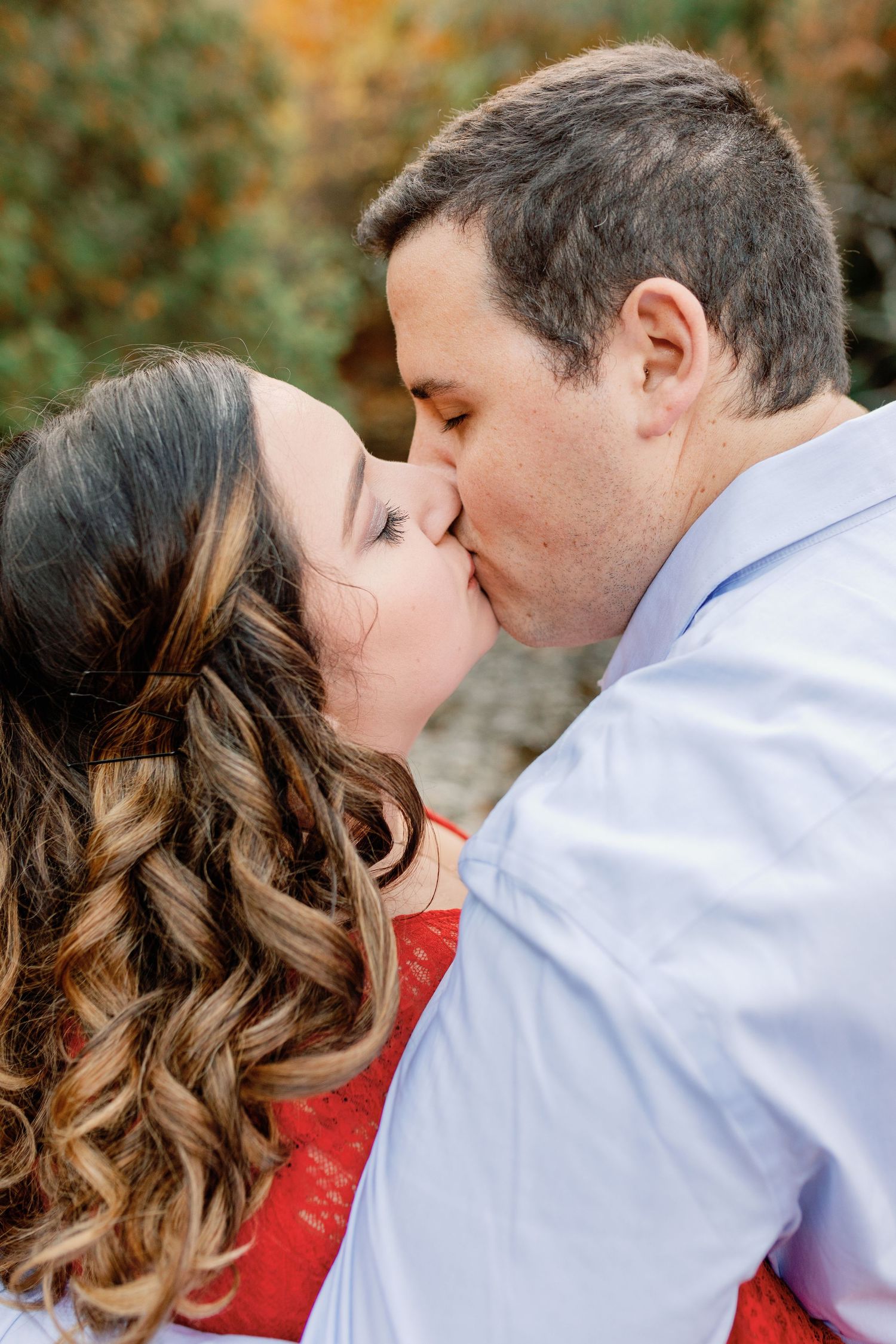 A close photo as a couple share a kiss. Moment captured by Katie Crane Photography.