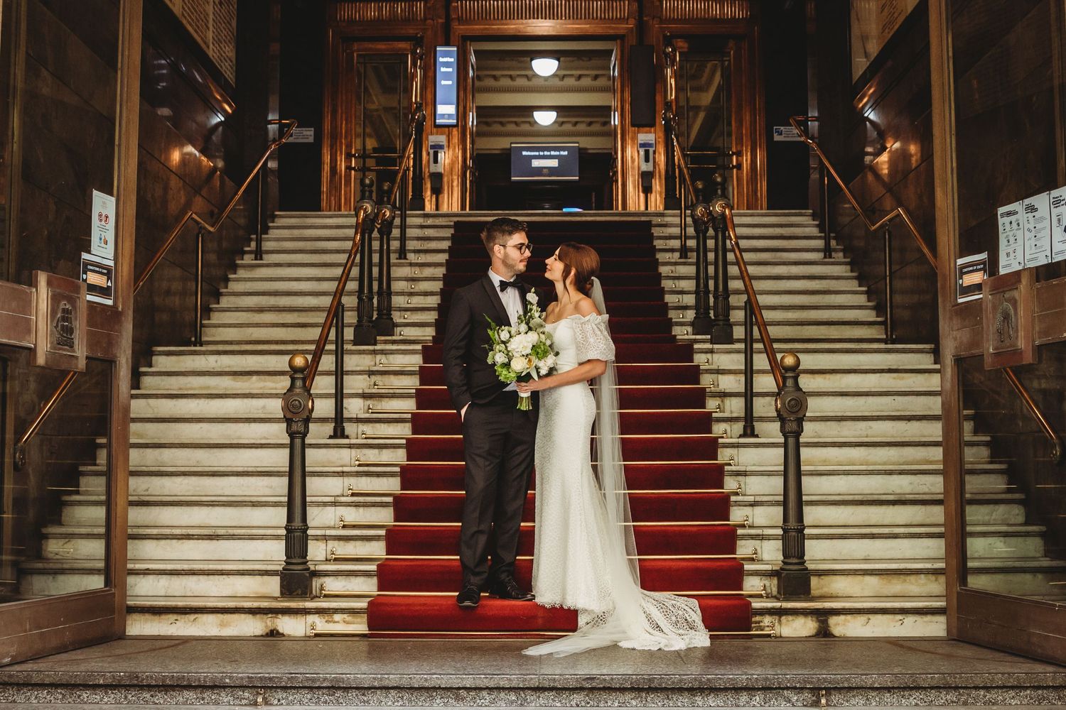 A Melbourne CBD wedding photographer captures an elegant urban wedding scene, with the couple sharing a romantic moment