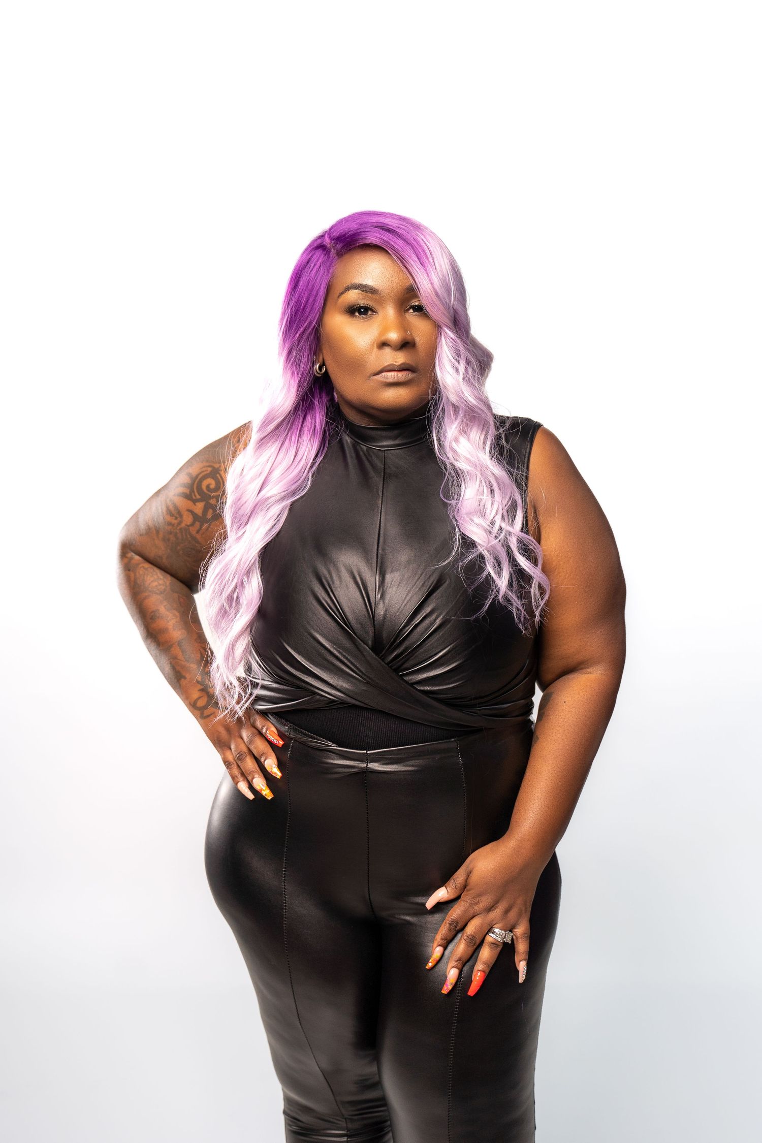 Fashion portrait featuring purple ombre hair and black sleeveless outfit.