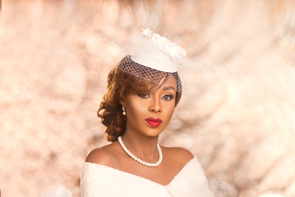 vanity fair inspired female bridal portrait with fascinator , pearl s and red lips