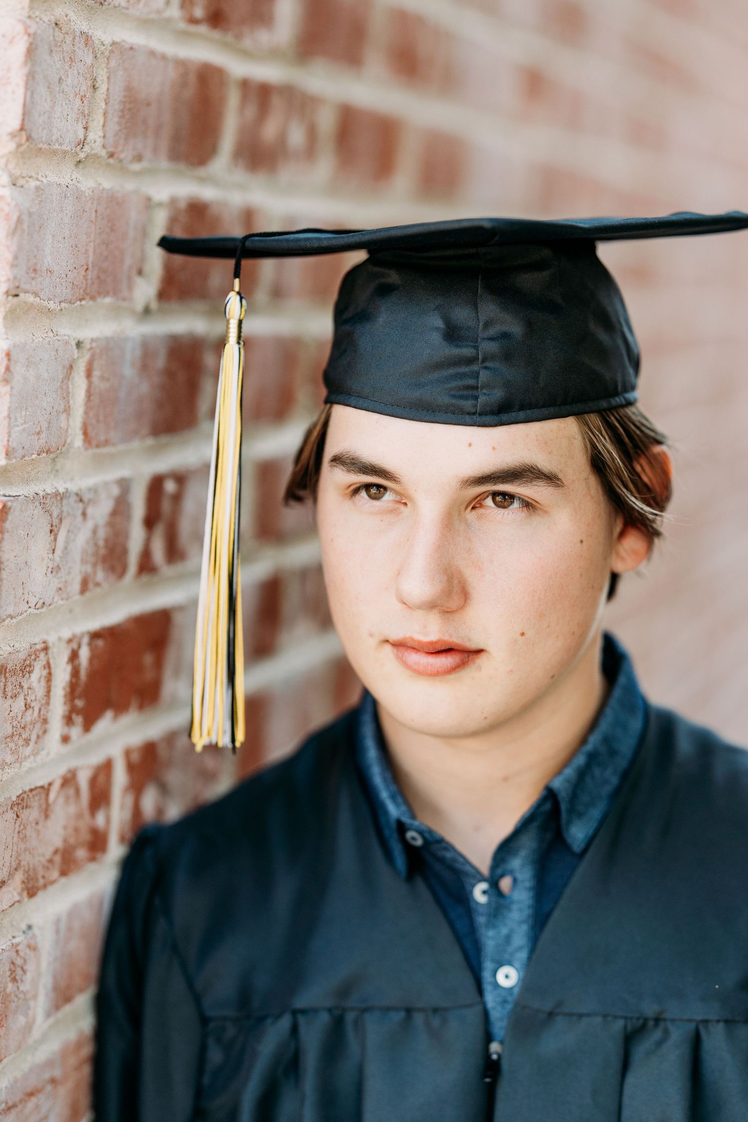 Headshot of a young adult with his cap and tassel.
