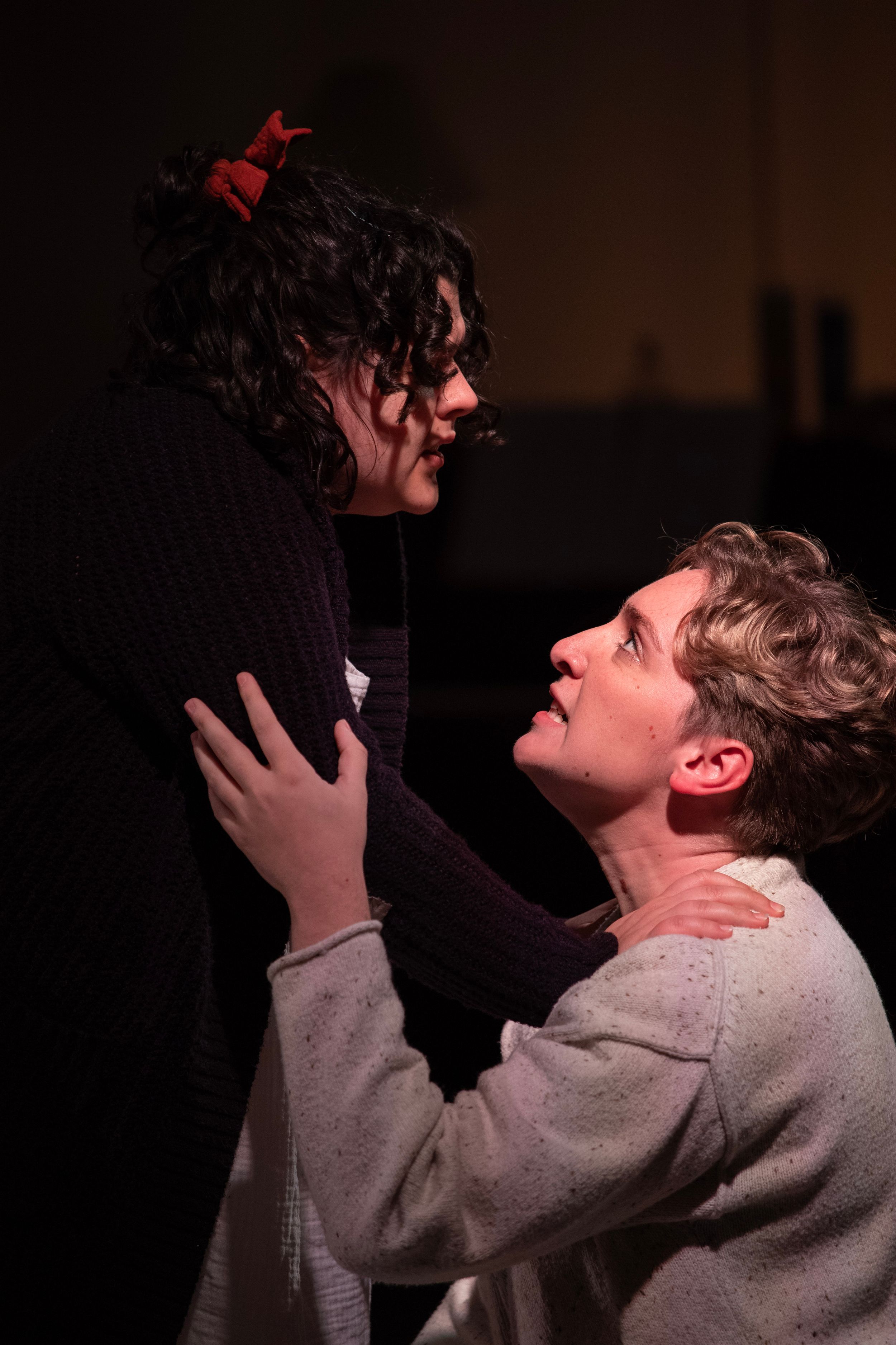 A dramatic scene from a theatrical performance showing two actors in an emotional embrace. From Mary's Wondrous Body in 2022.