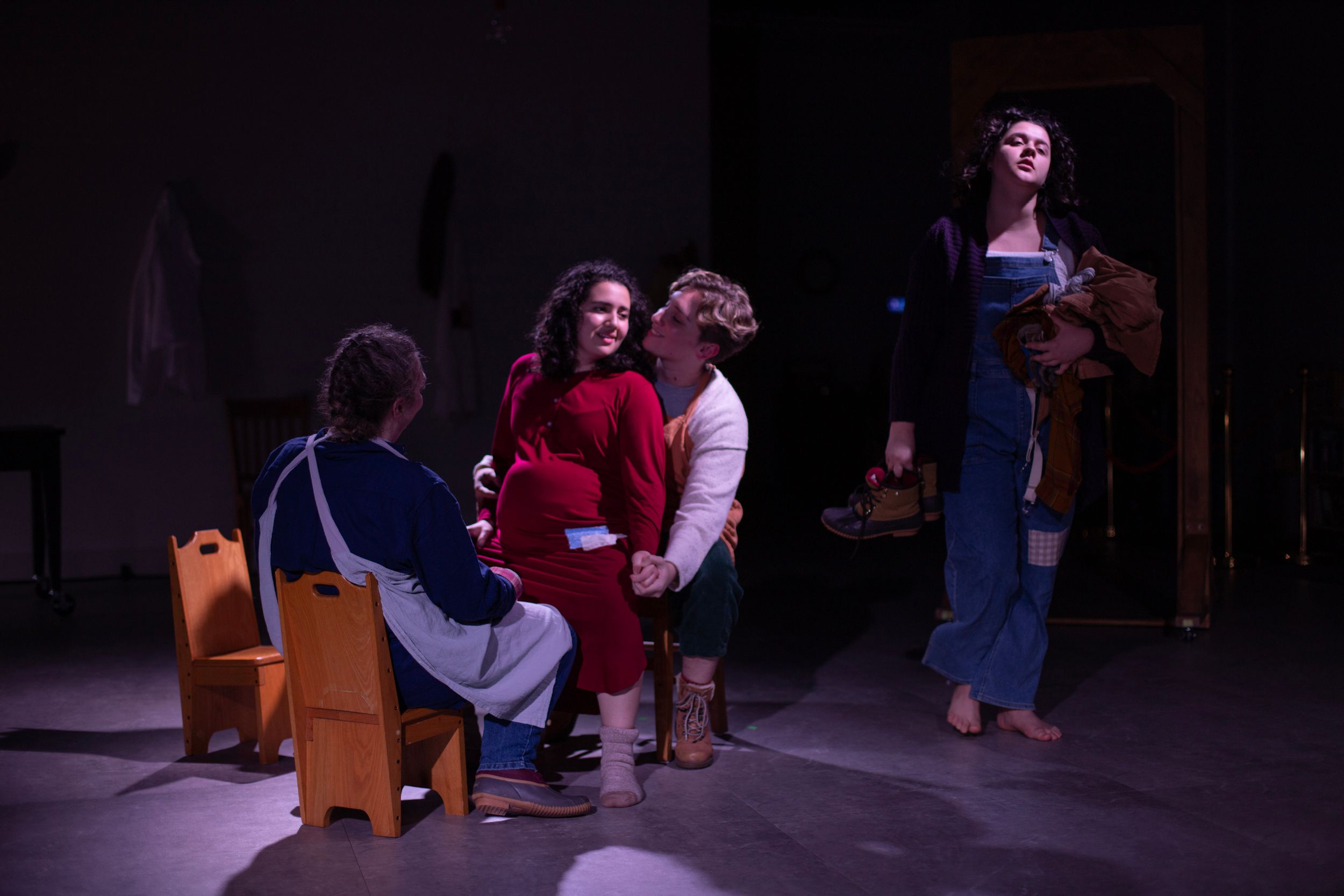 Theatre performers gather on stage preparing for a family member to give birth. From Mary's Wondrous Body in 2022.
