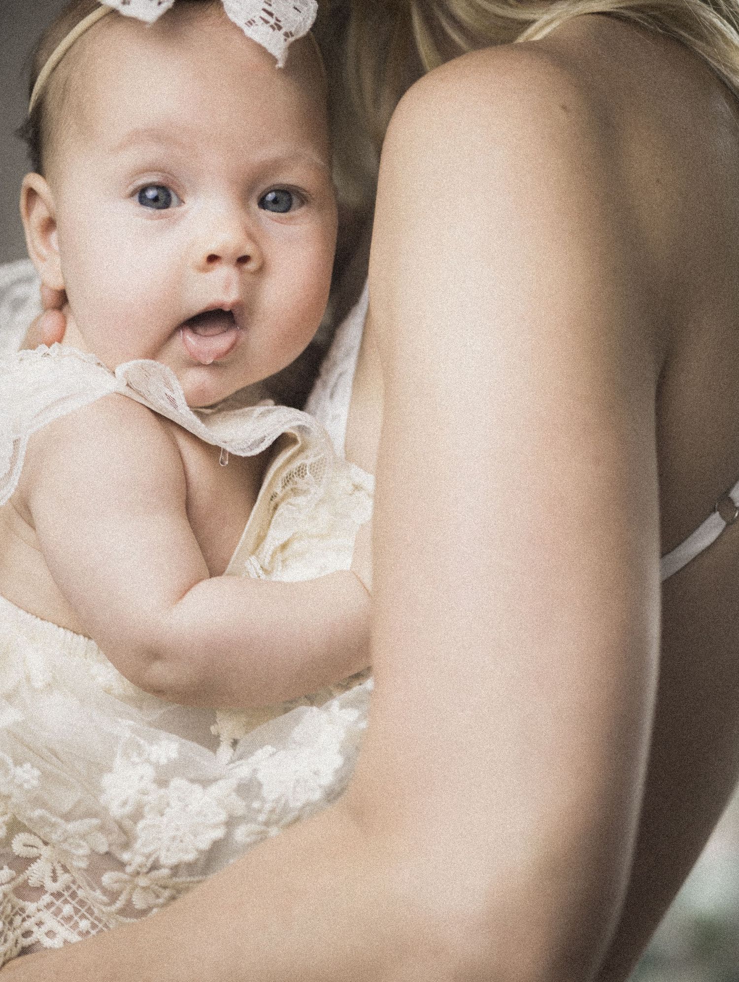 Baby in her mother’s arms.  Fine Art, sepia toned.