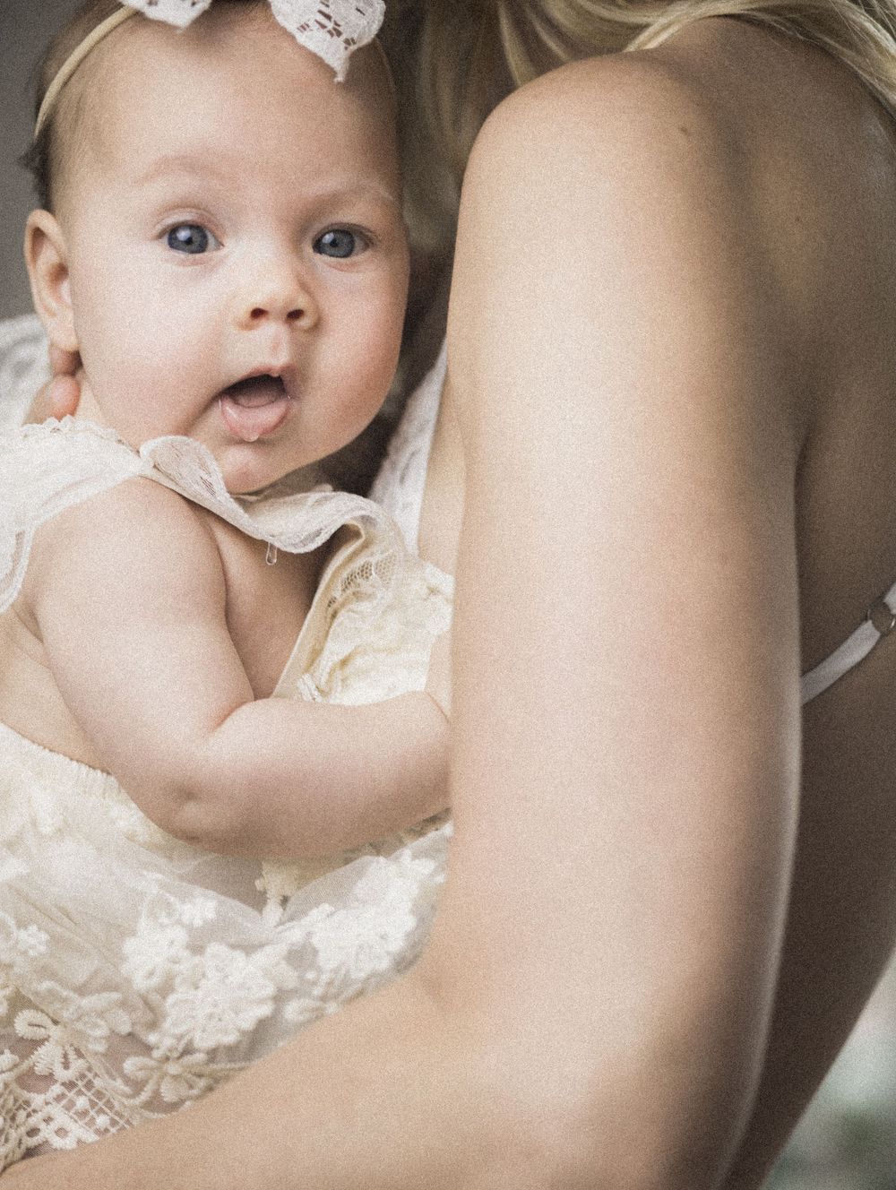 Baby in her mother’s arms.  Fine Art, sepia toned.