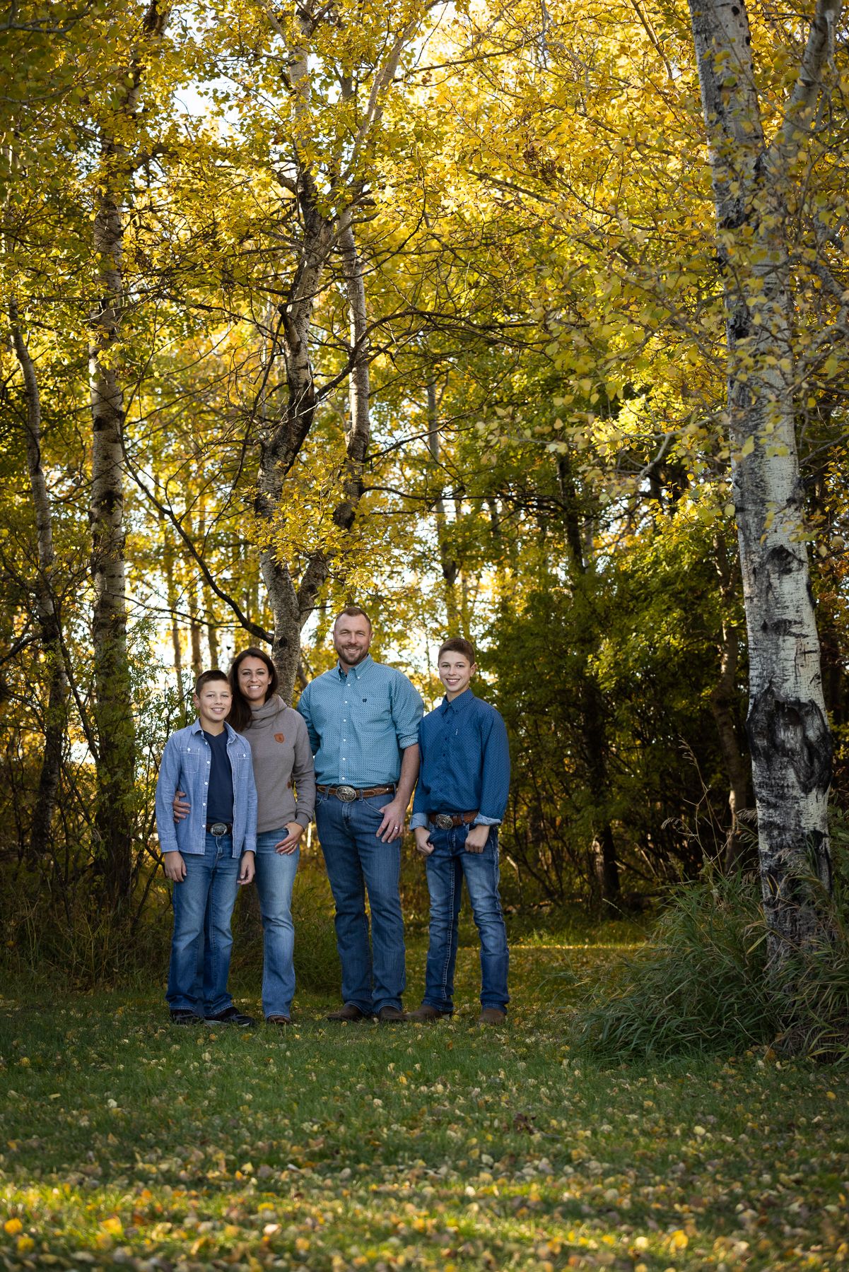 mom, dad and two sons in fall surroundings