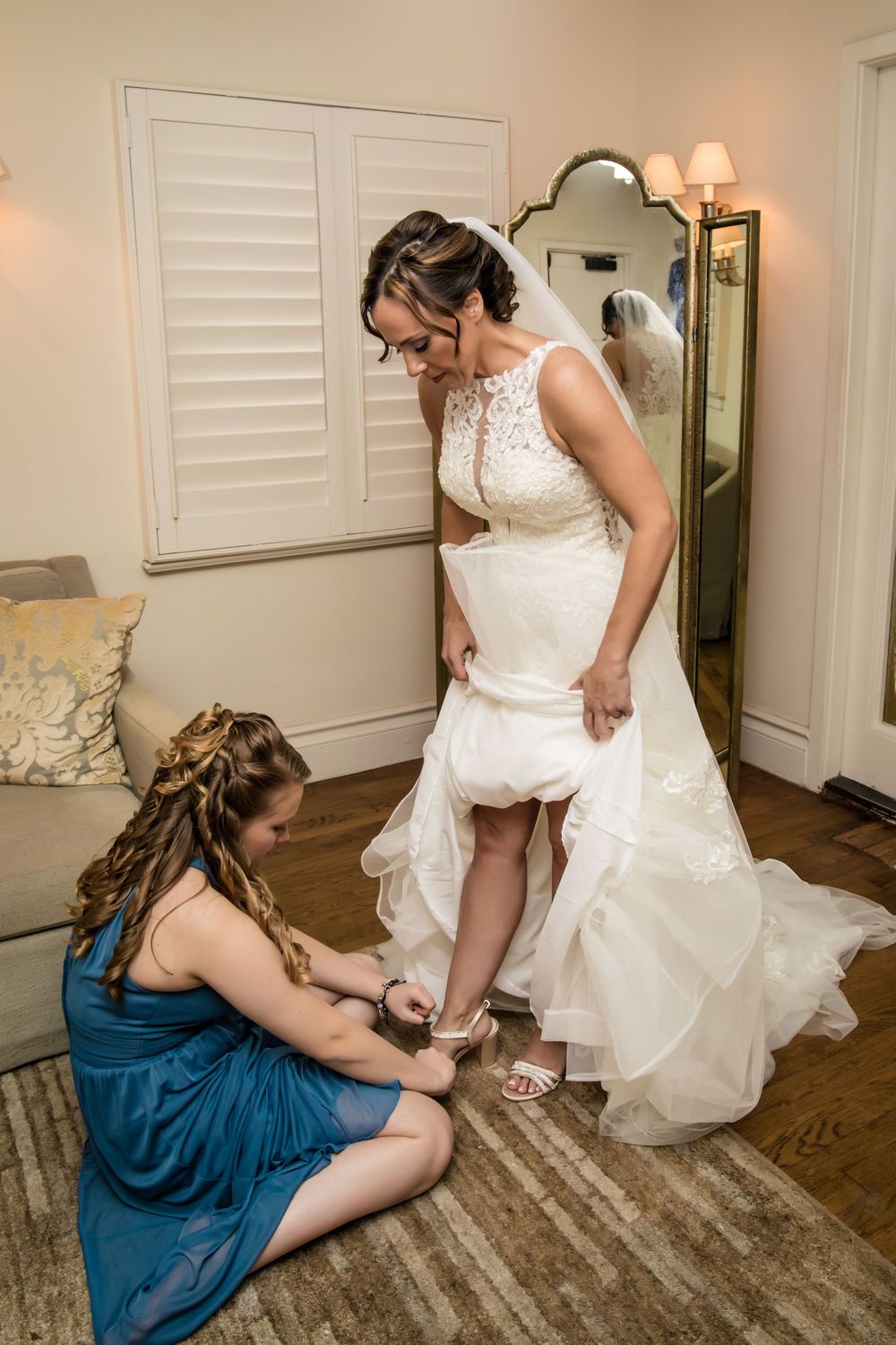 Wedding dress preparation with final adjustments being made to the gown.