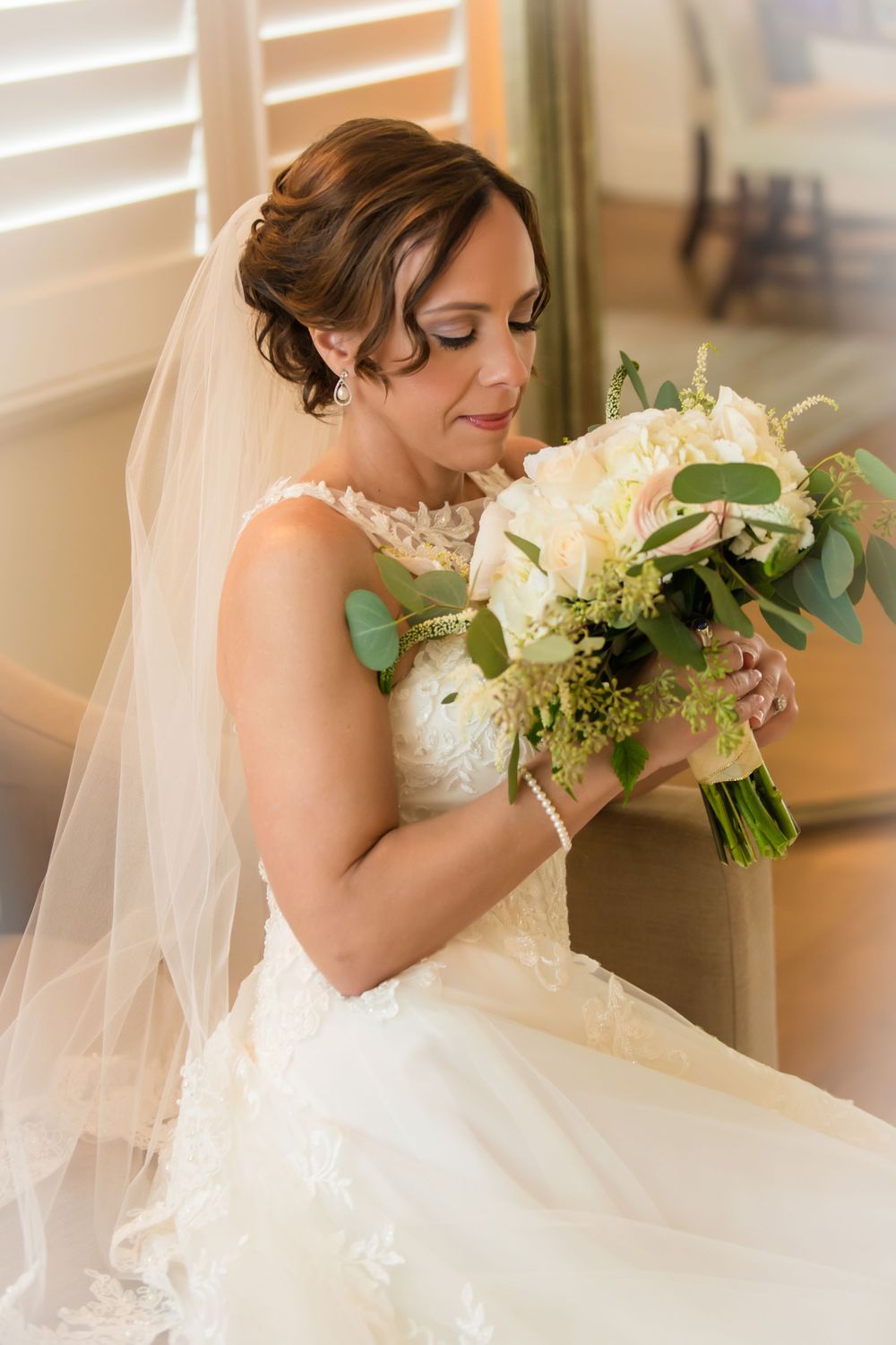 A white wedding dress with delicate lace details and flowing tulle.