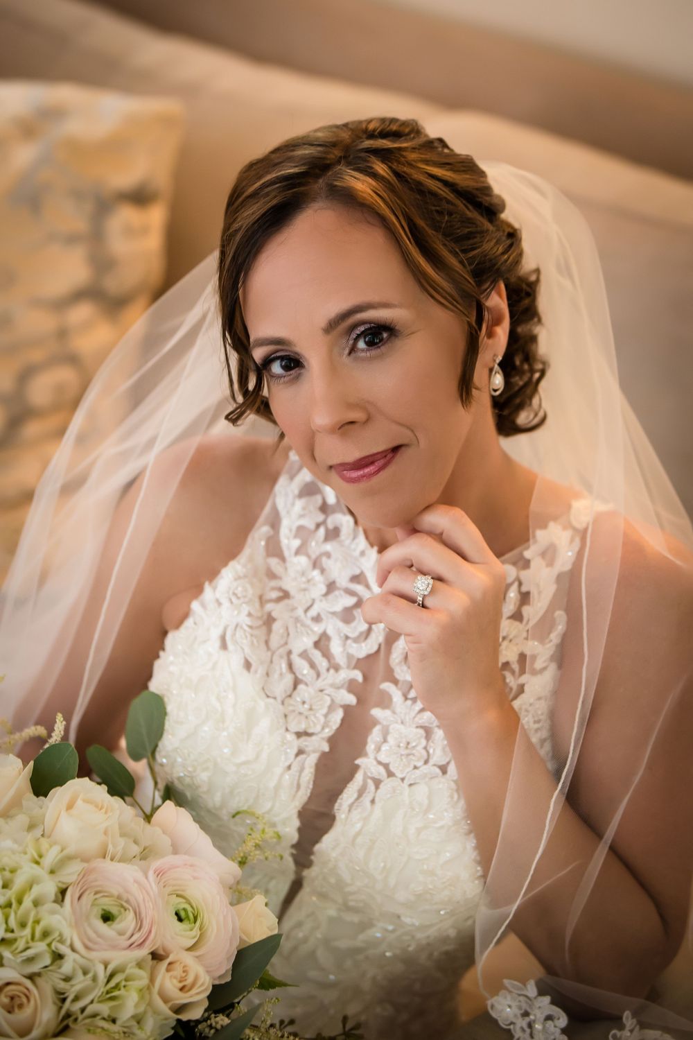 Elegant bridal portrait showcasing lace details and a flowing veil.