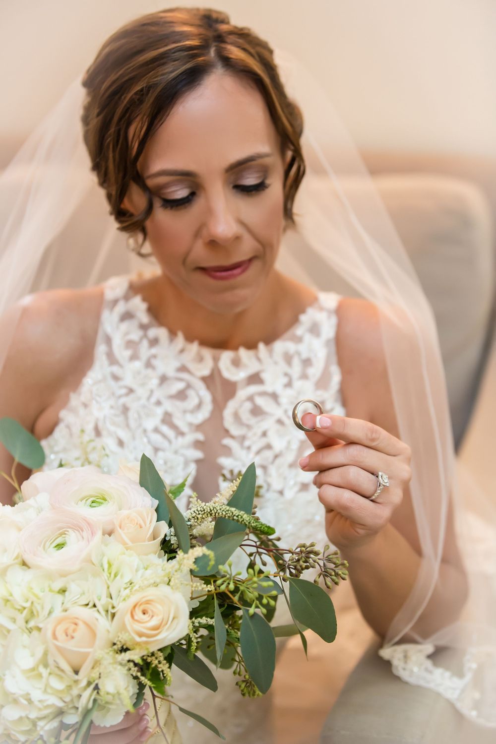 Bridal bouquet of cream roses and hydrangeas with soft green foliage.