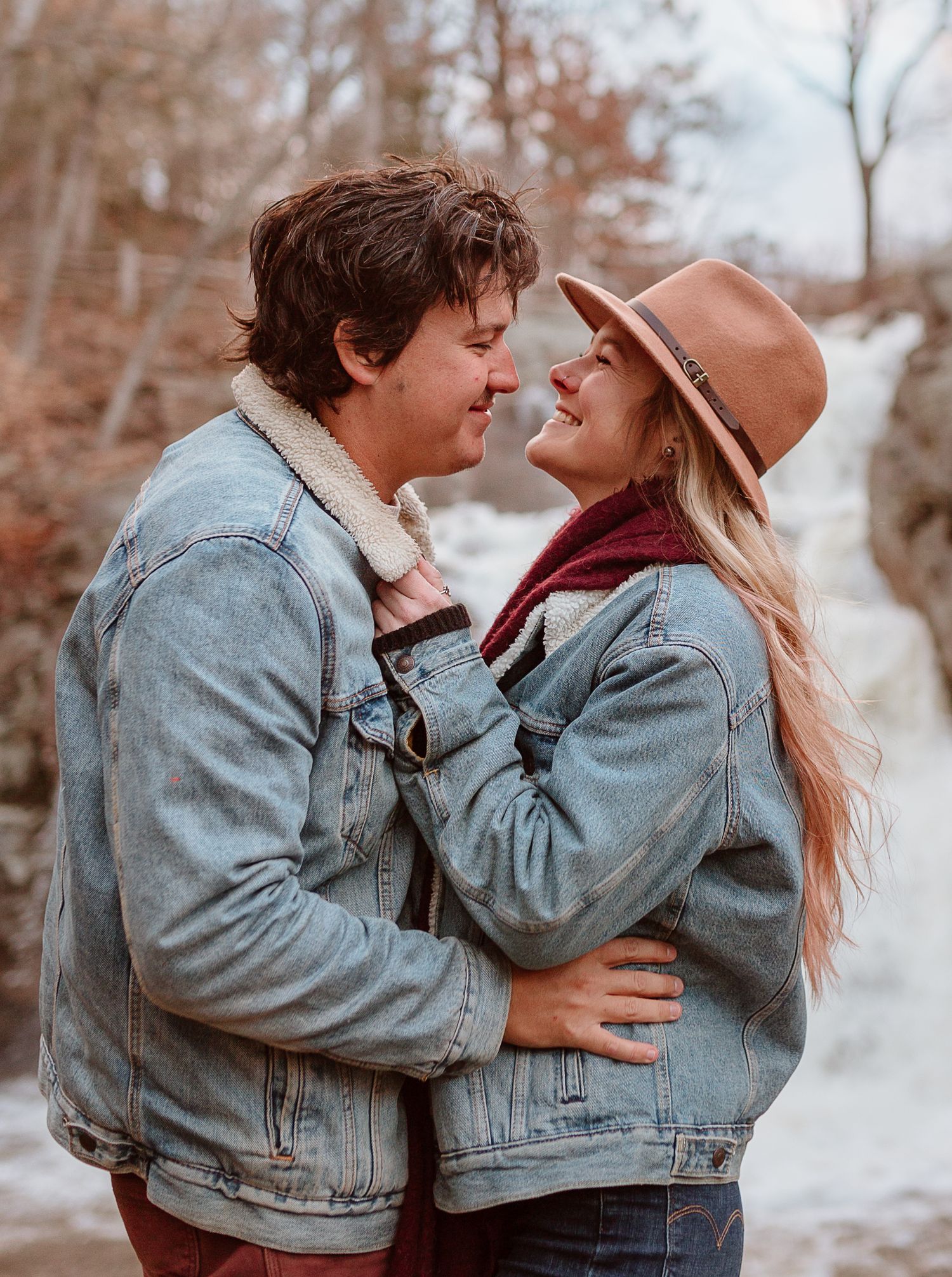 connecticut couple poses in front of waterfall at devils hopyard in CT for couples photo session