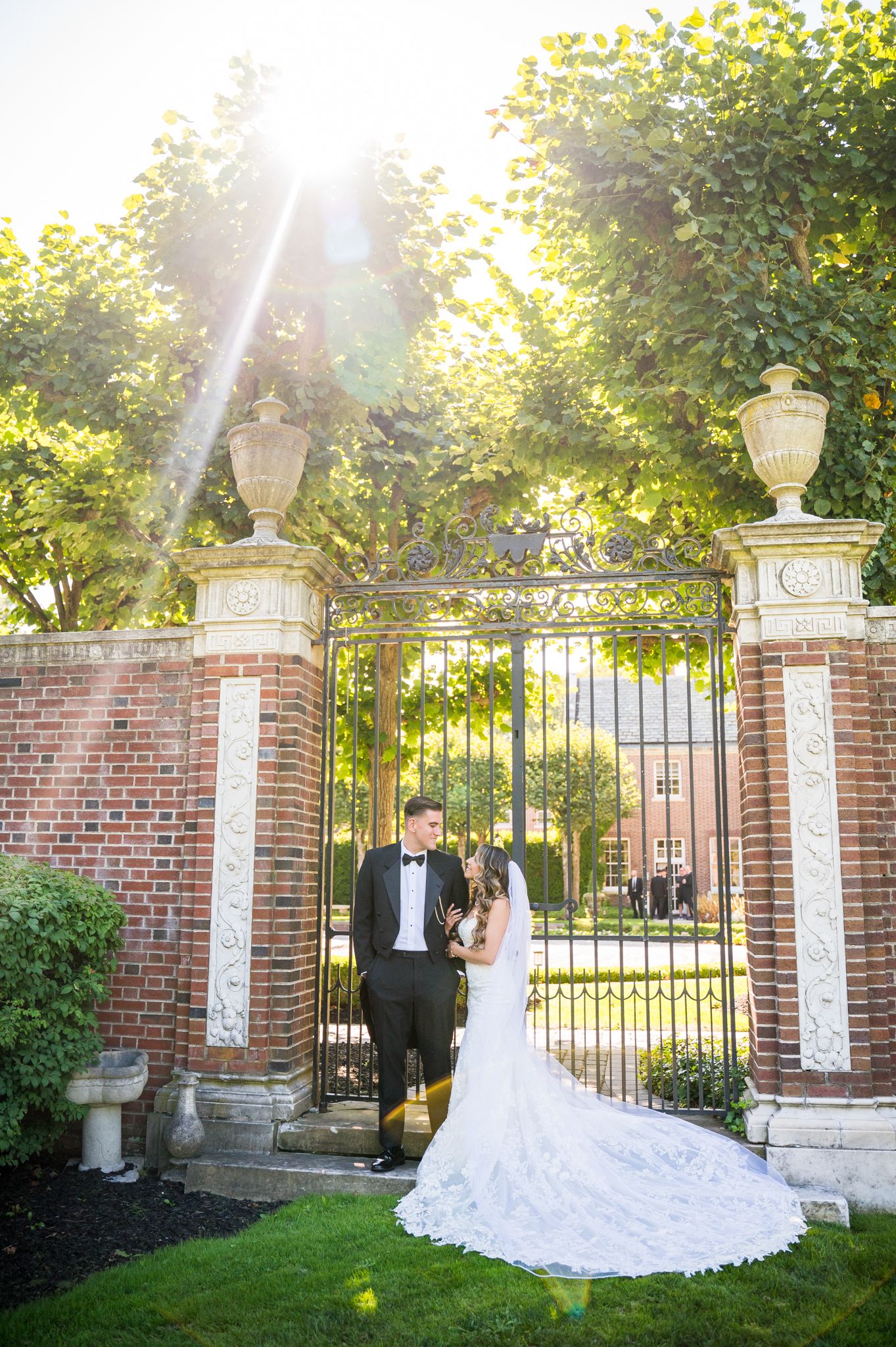 Couple gazing into each other's eyes with the radiant sun peeking out from behind them.
