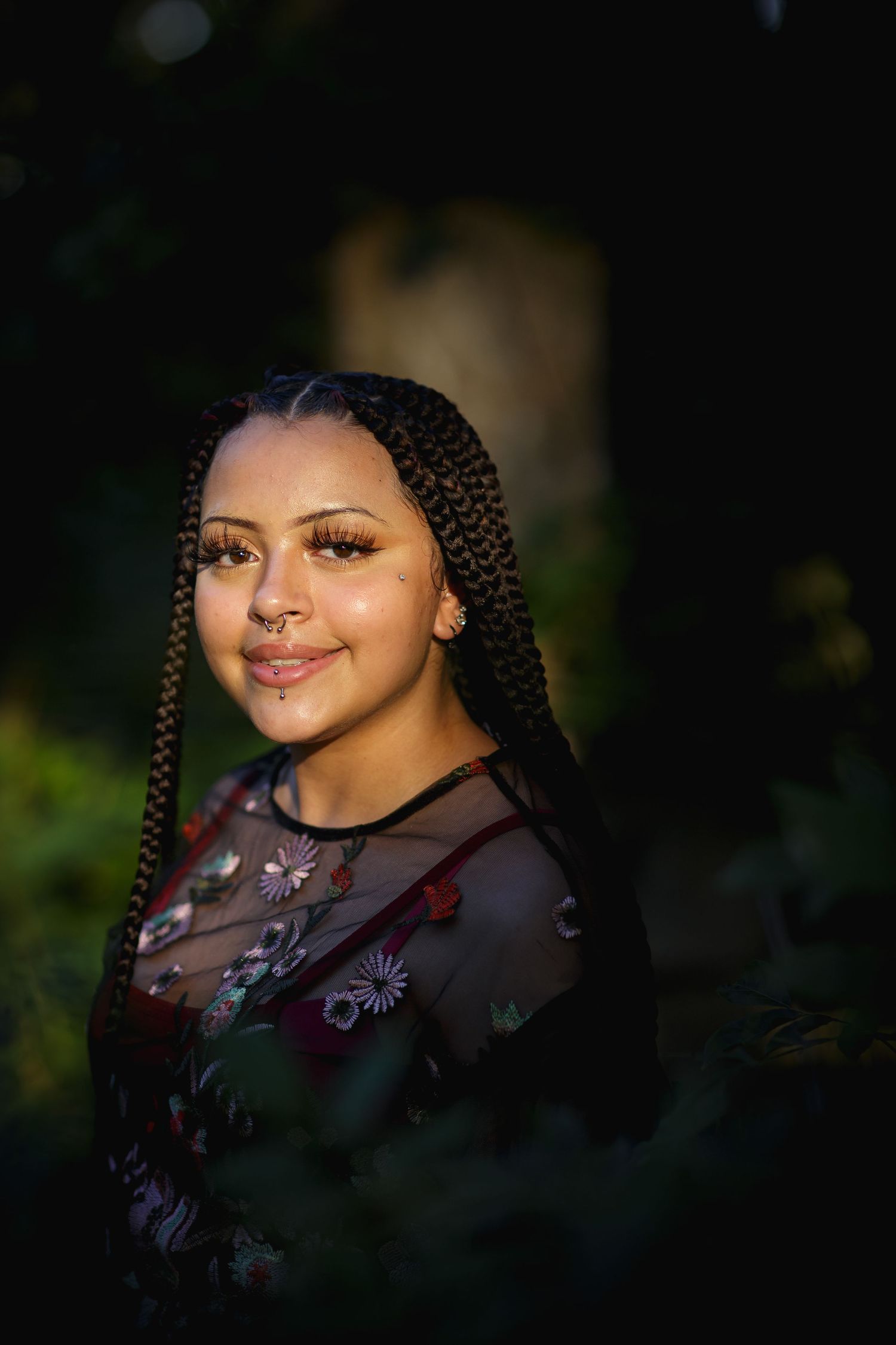 A portrait glowing in natural light features braided hair and floral sheer clothing, Denison, Texas