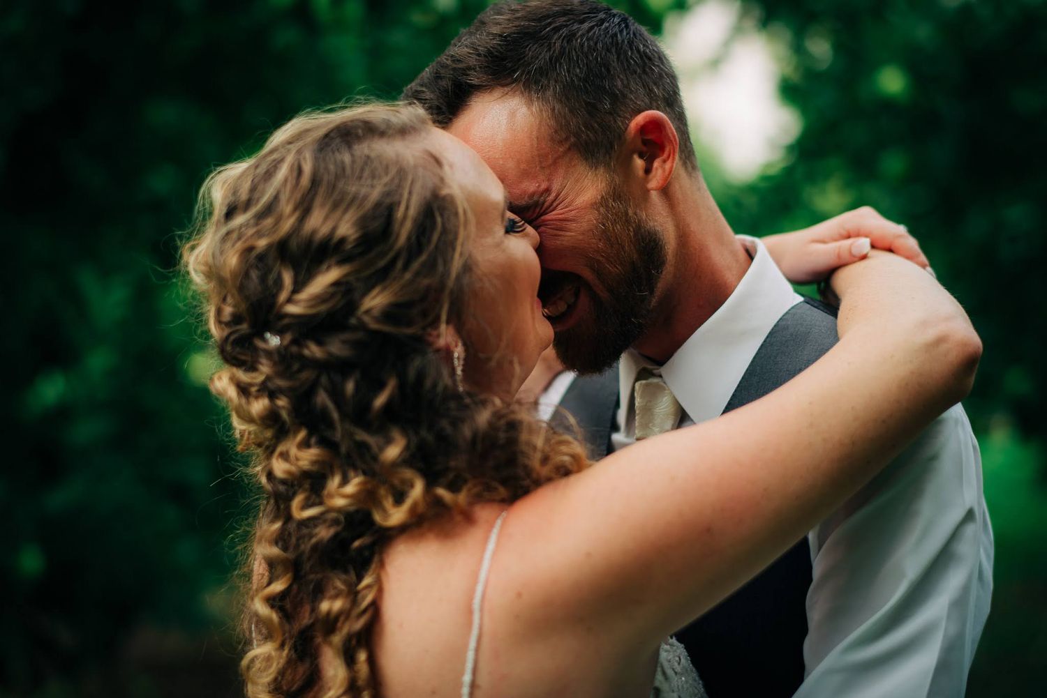 Bride & Groom kiss in apple orchard after outdoor wedding in Manson, WA